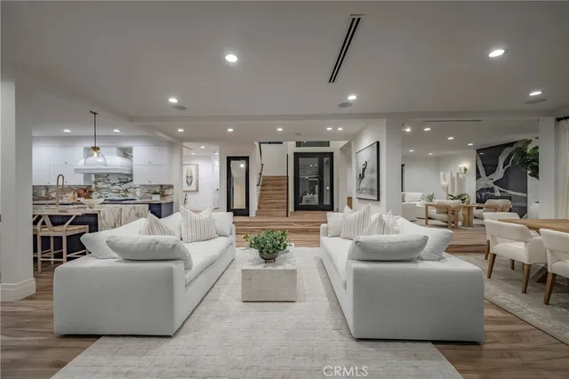 a living room with furniture and kitchen view