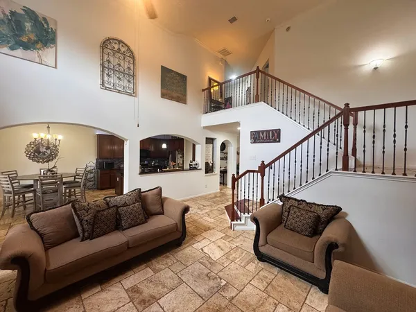 a living room with furniture and a chandelier