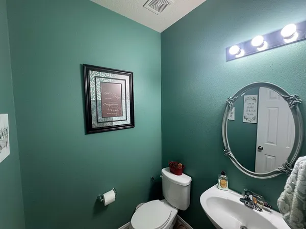 a bathroom with a toilet mirror and toilet