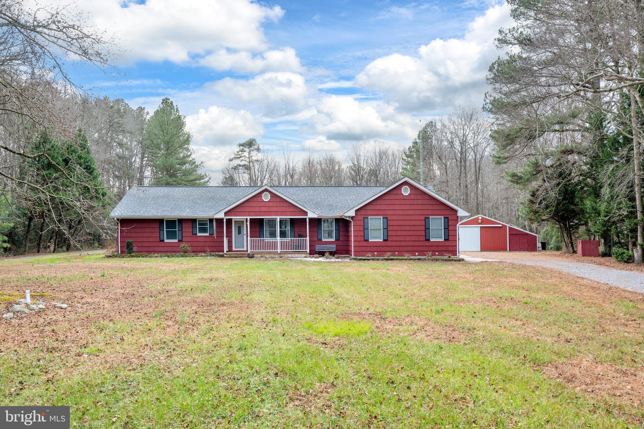 a large house with a big yard and large trees