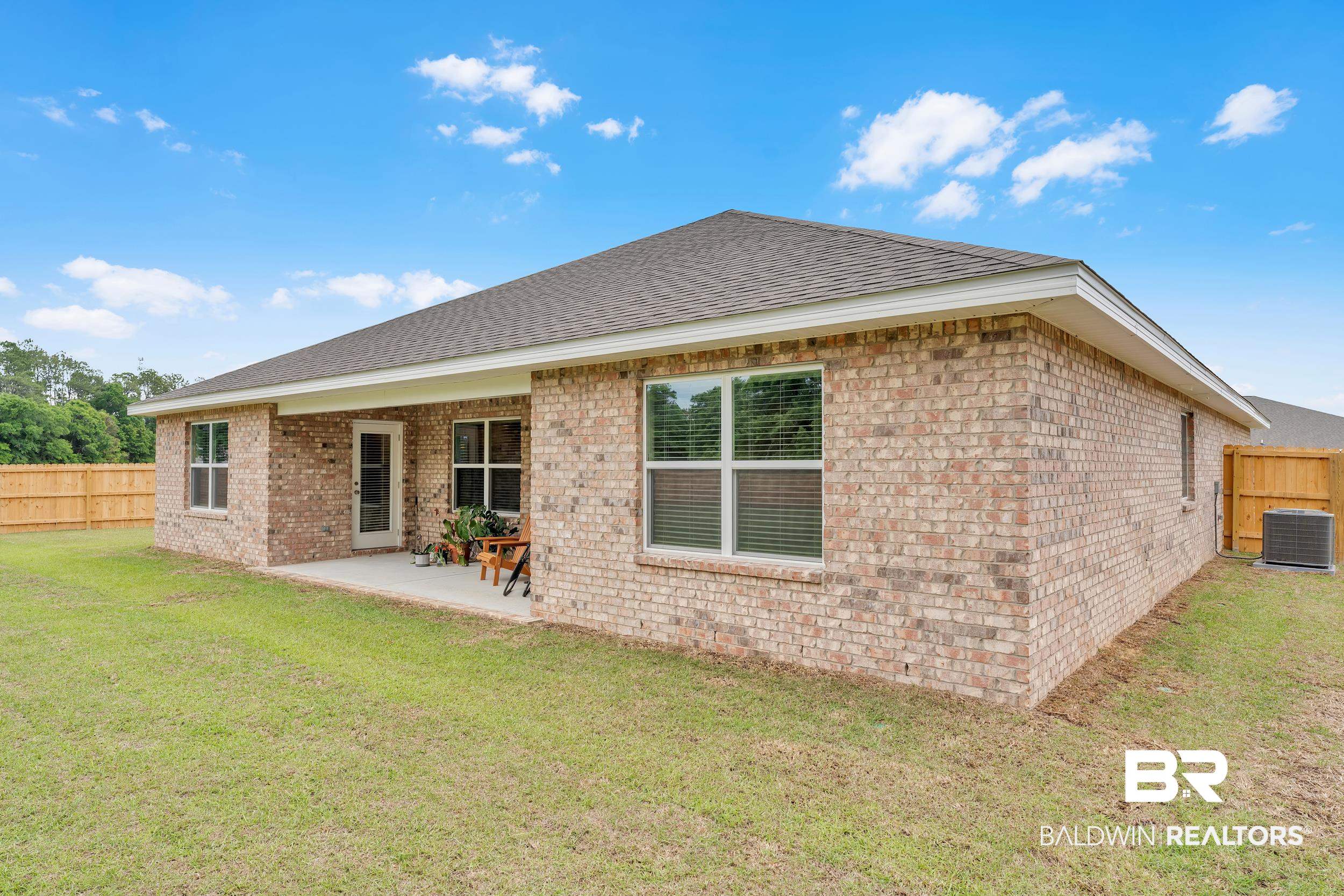 24460 Ringneck Loop Elberta, AL 36530 - Photo 5 of 46 Rear view of house with a patio, brick siding, fence, and cooling unit