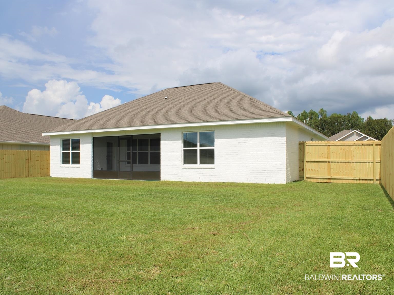 24385 Ringneck Loop Elberta, AL 36530 - Photo 30 of 33 Rear view of house featuring a lawn