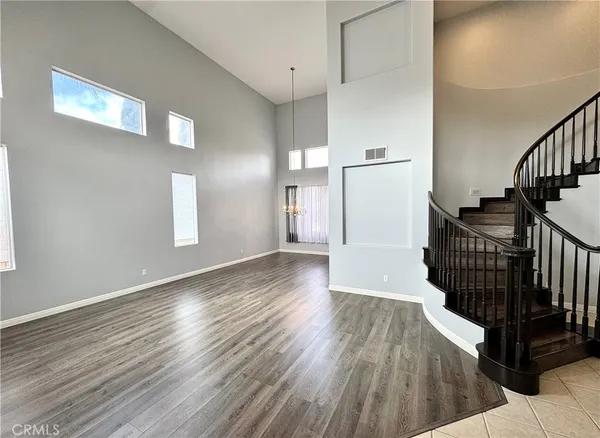 a view of a hallway with wooden floor and staircase