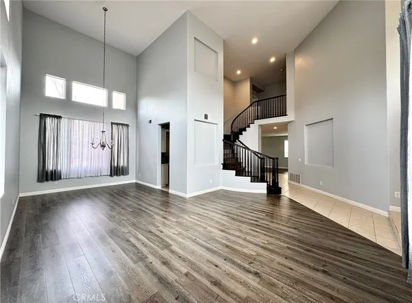 a view of a hallway with wooden floor and stairs