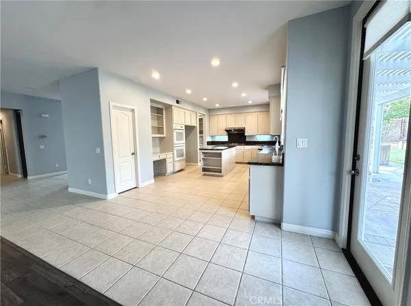a view of an empty room with wooden floor and closet