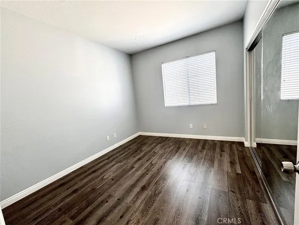 a view of a patio with table and chairs potted plants and large tree