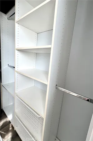 a view of a swimming pool with a lawn chairs yard and palm trees