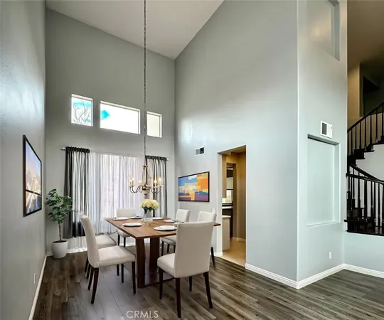 a spacious bedroom with a bed and a chandelier