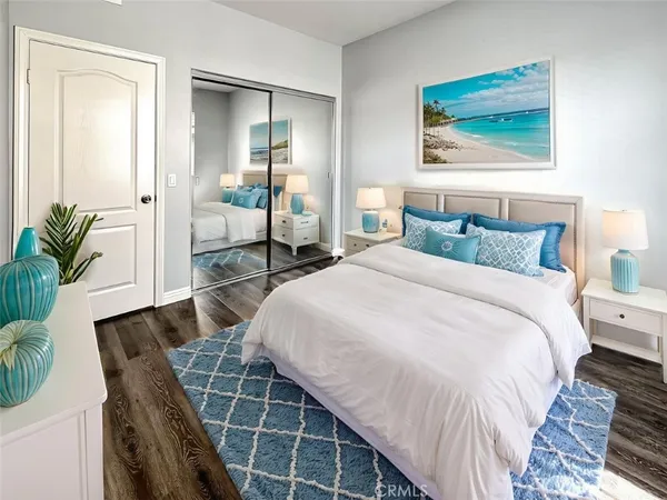 a view of a kitchen with wooden floor and electronic appliances
