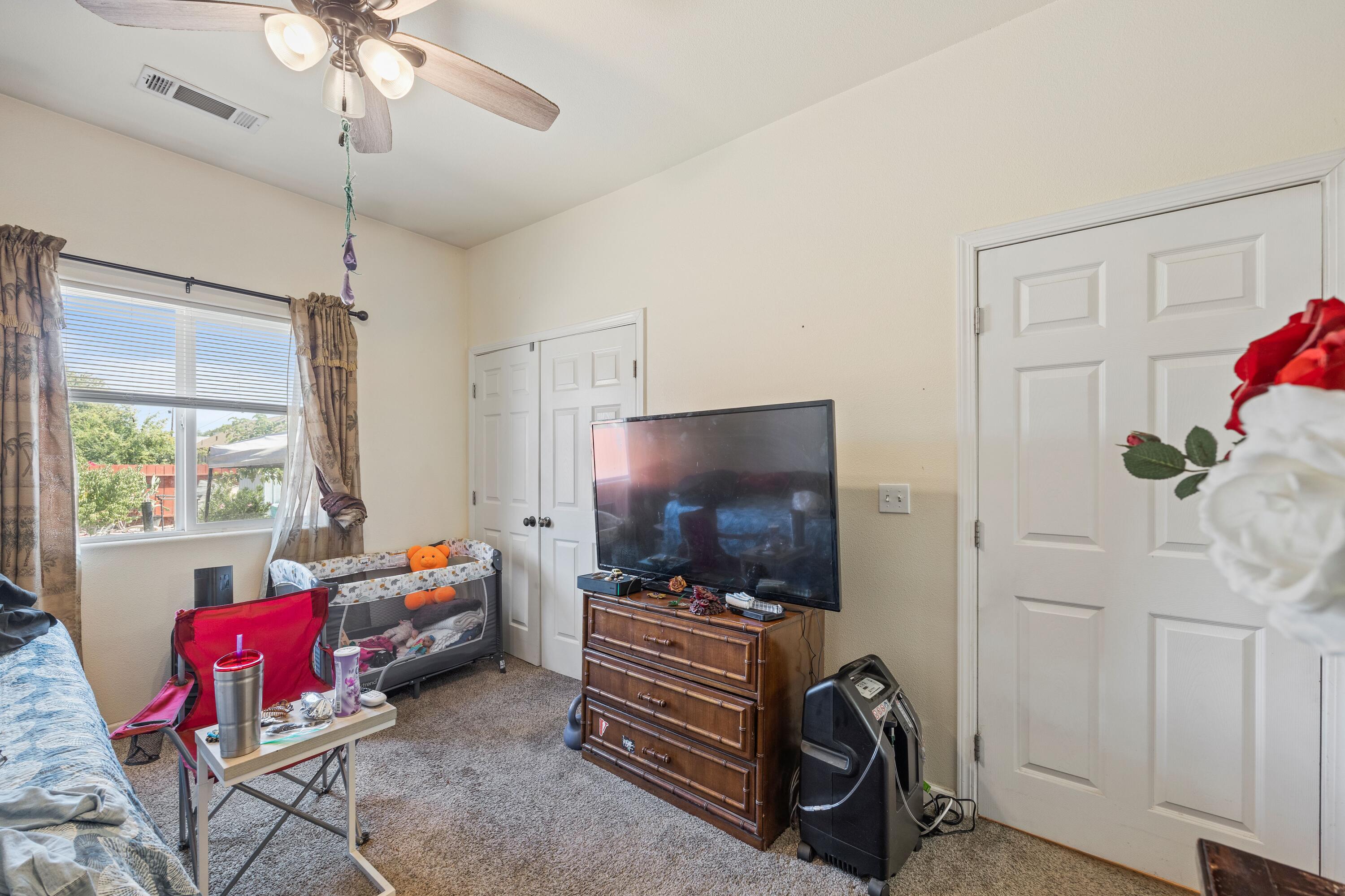 1052 South Klein Avenue Reedley, CA 93654 - Photo 7 of 10 a living room with furniture and a flat screen tv