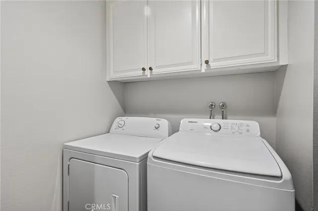 a view of backyard with seating space and wooden fence