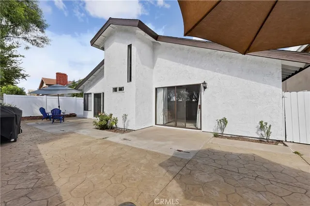 an aerial view of a house with a yard and potted plants