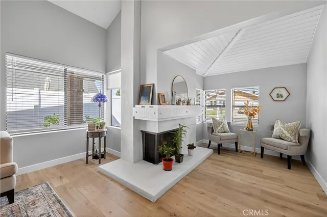 a living room with furniture wooden floor and a fireplace
