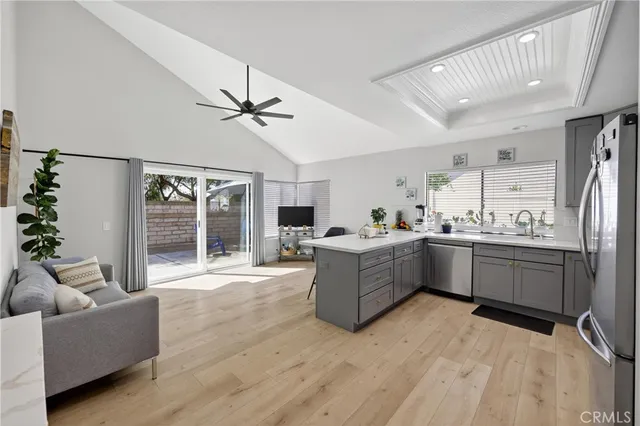 a kitchen with stainless steel appliances a refrigerator and a stove top oven