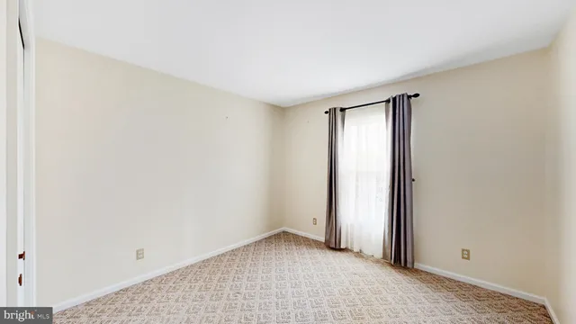 a bedroom with a bed and a potted plant