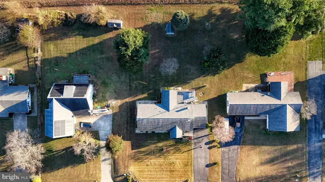 an aerial view of a house with swimming pool and lake view