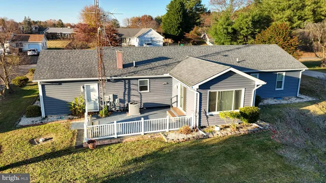 an aerial view of residential houses with outdoor space and river