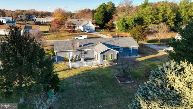 a view of a house with wooden fence
