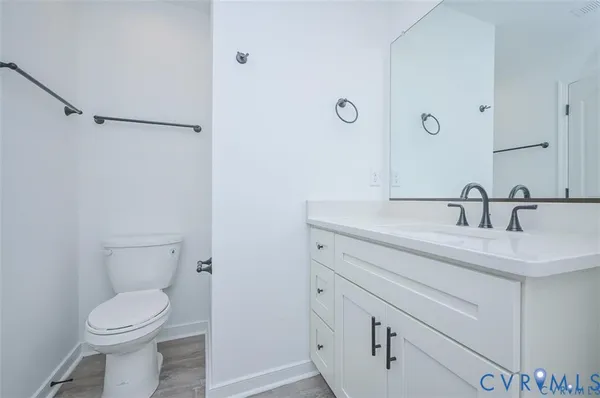 a bathroom with a sink toilet and mirror