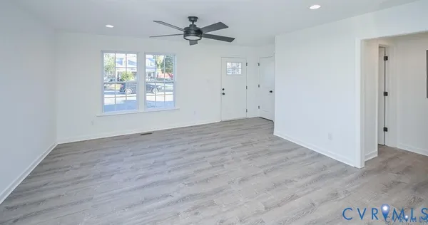wooden floor in an empty room with a window