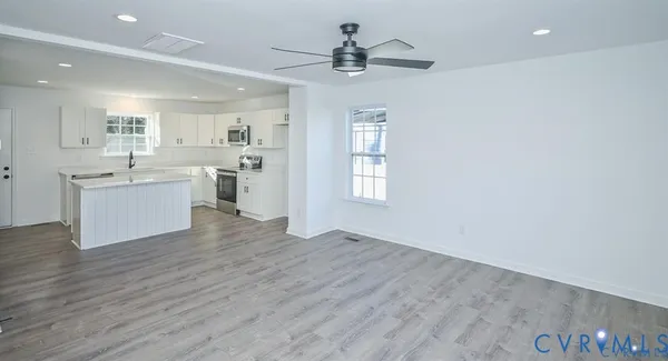 a view of a kitchen with a sink dishwasher cabinets and a kitchen