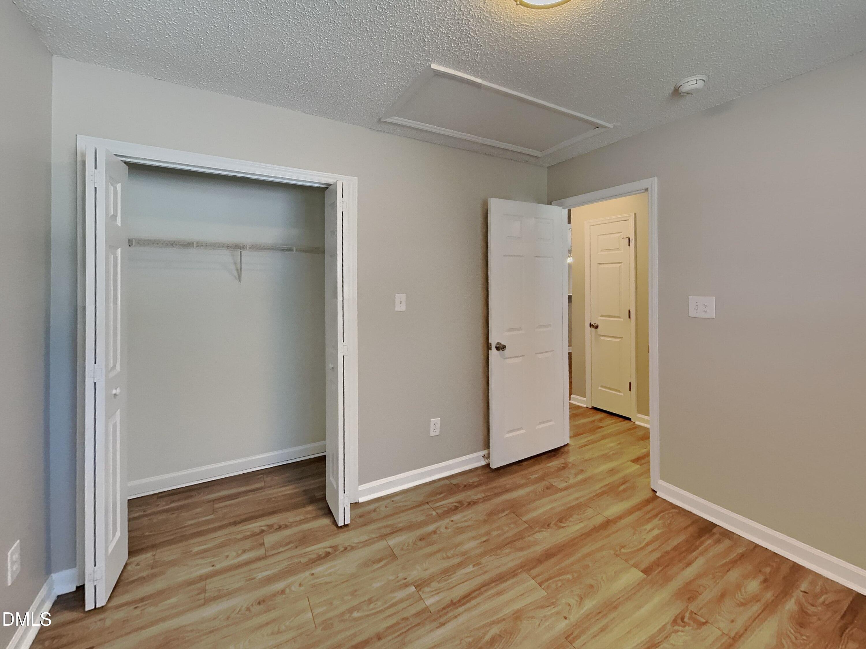 5516 Wilhagan Court Raleigh, NC 27616 - Photo 10 of 16 an empty room with wooden floor & closet and windows
