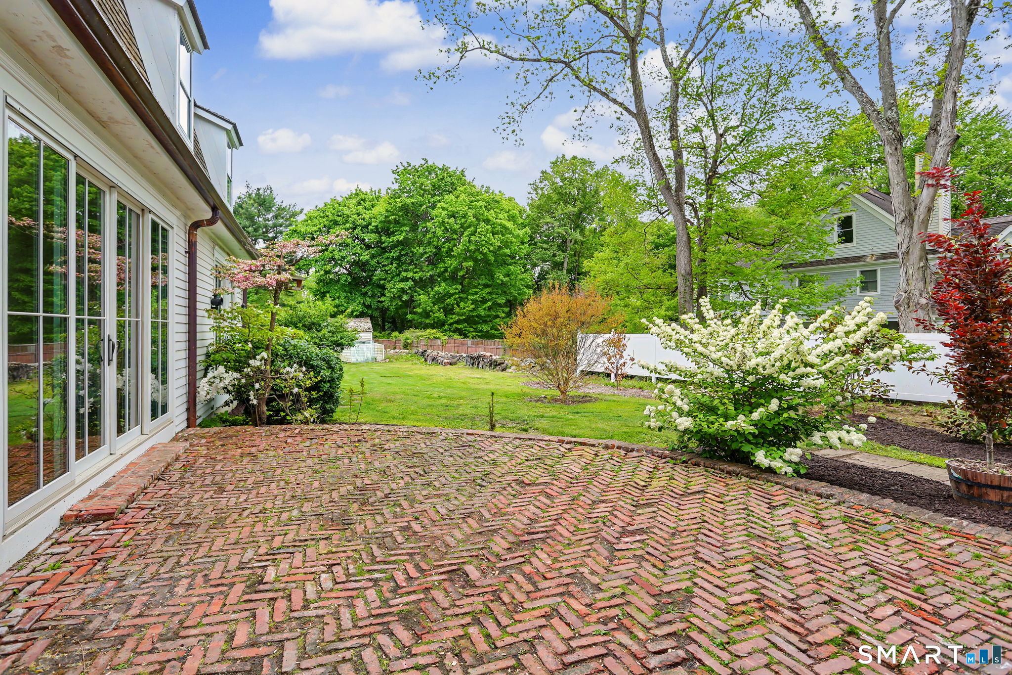 530 Roxbury Road Stamford, CT 06902 - Photo 35 of 40 Brick Patio enters the house through all the floor-to-ceiling sliders and is tucked away for privacy