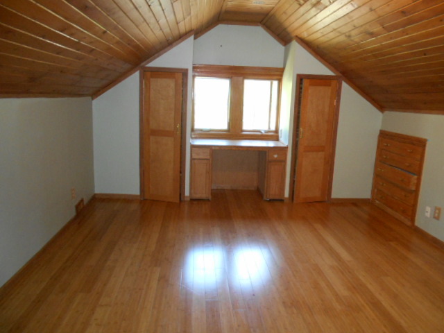 319 East Devlin Street Spring Valley, IL 61362 - Photo 12 of 19 an empty room with wooden floor and windows