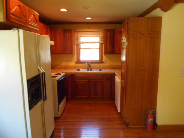 319 East Devlin Street Spring Valley, IL 61362 - Photo 3 of 19 a kitchen with stainless steel appliances a refrigerator sink and wooden floor