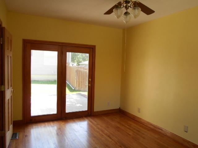 319 East Devlin Street Spring Valley, IL 61362 - Photo 4 of 19 an empty room with wooden floor and windows