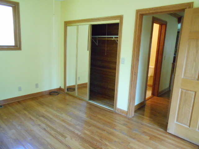 319 East Devlin Street Spring Valley, IL 61362 - Photo 8 of 19 an empty room with wooden floor and closet