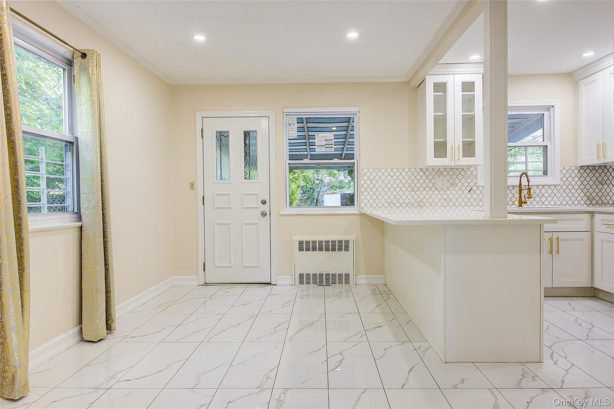 164-38 76th Road Queens, NY 11366 - Photo 6 of 44 a view of kitchen with windows and refrigerator