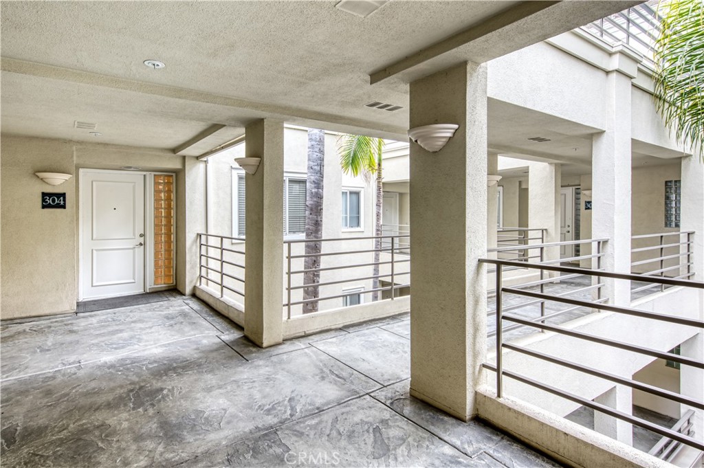 2243 Martin, Unit 304 Irvine, CA 92612 - Photo 1 of 1 a view of a hallway with entryway and chandelier