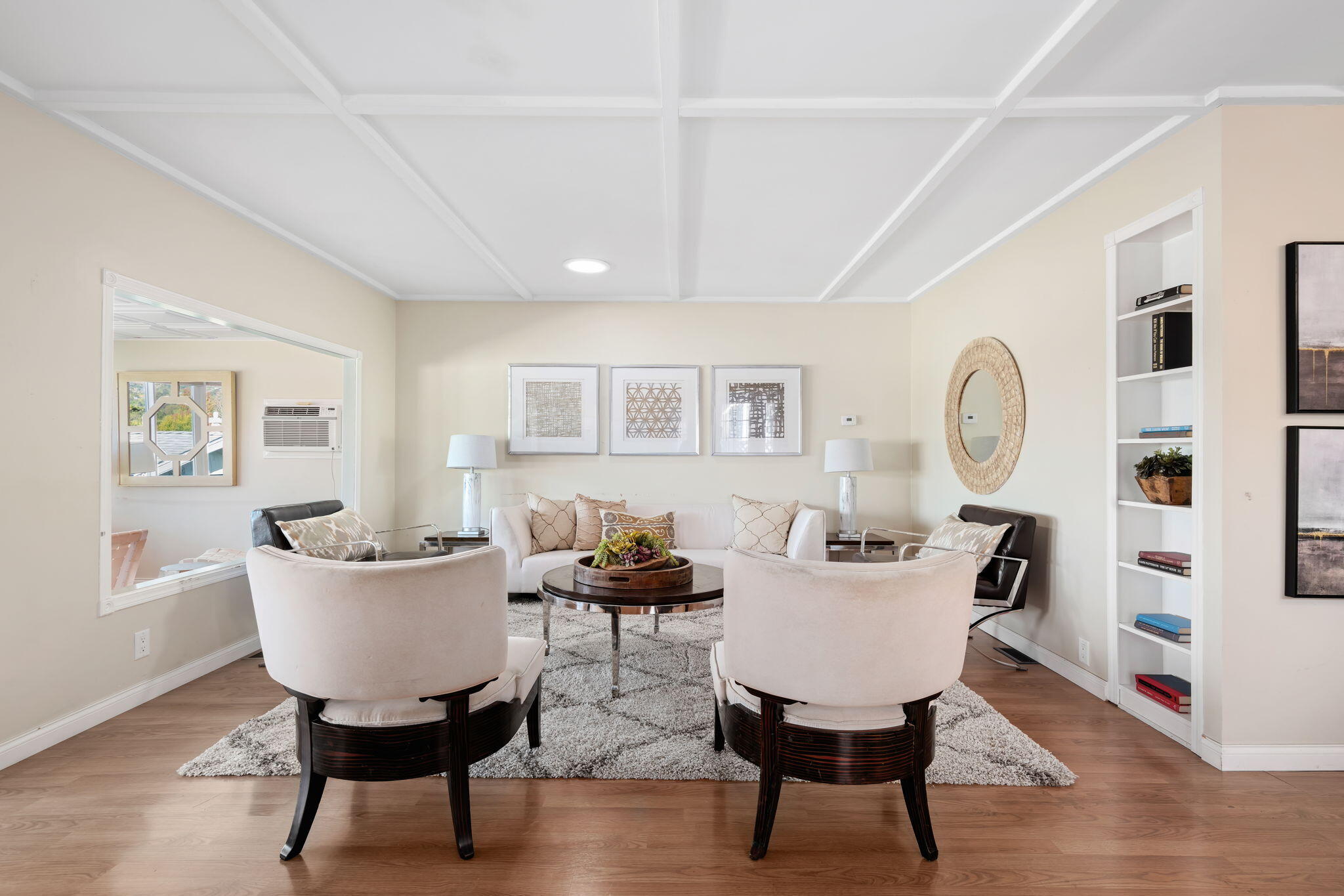 a view of a dining room with furniture a rug and wooden floor
