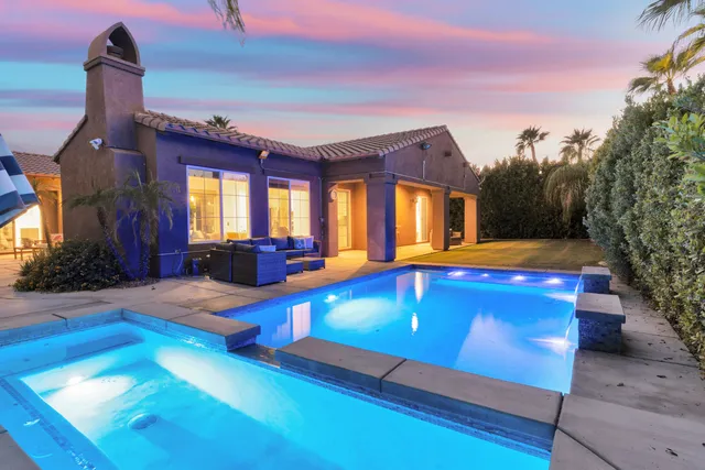 a view of swimming pool with lounge chair and dinning room