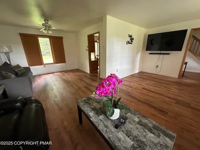 a living room with furniture and a flat screen tv