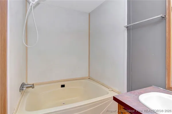 a bathroom with a granite countertop shower and a sink