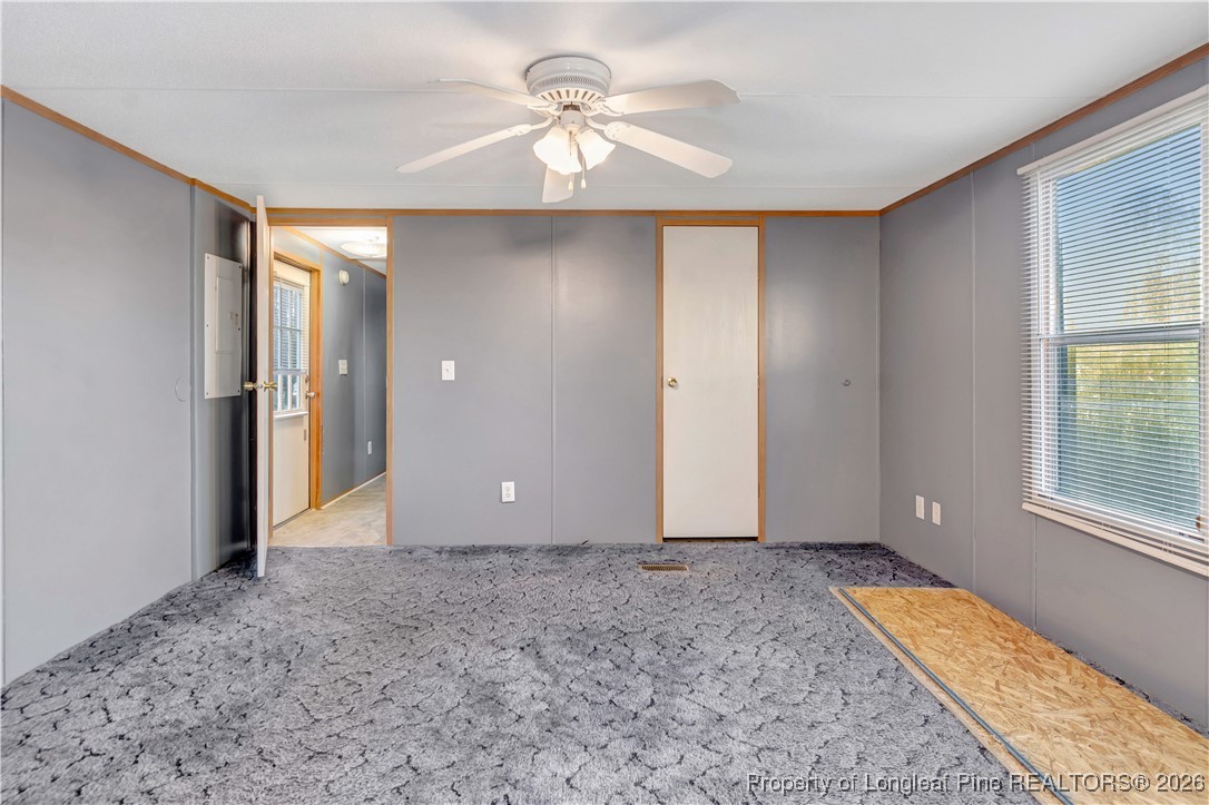 6461 Wire Grass Road Orrum, NC 28369 - Photo 10 of 22 a view of an empty room with windows