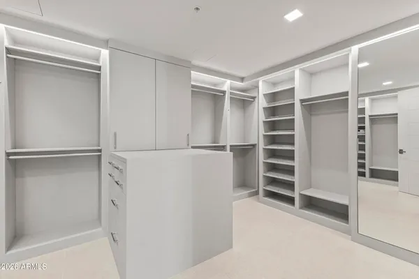 a hallway with closet and dresser