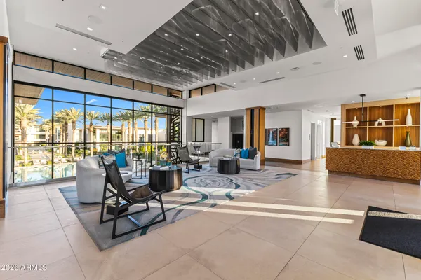 a living room with furniture and large windows