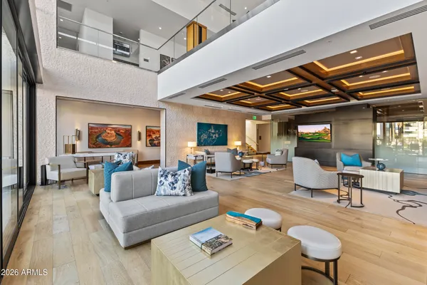 a living room with furniture and a chandelier