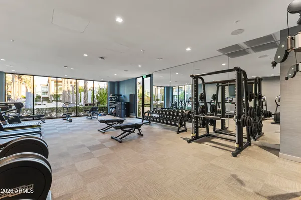 a view of a dining room with furniture large windows and wooden floor