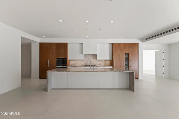 a large kitchen with kitchen island a sink stainless steel appliances and cabinets