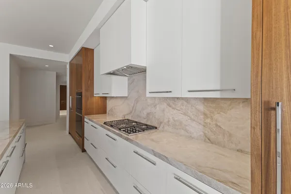 a view of kitchen with furniture and refrigerator