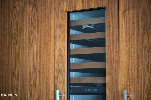 a kitchen with granite countertop a sink and a stove with white cabinets