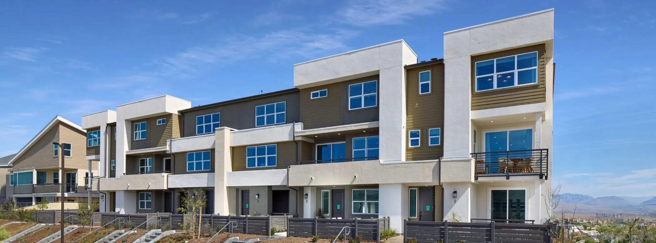 a front view of a residential apartment building with a yard