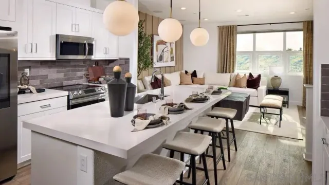 a kitchen with a dining table chairs and a microwave