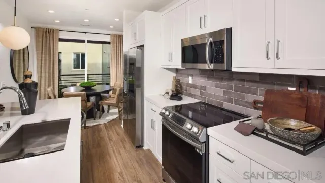 a kitchen with granite countertop a stove and a sink