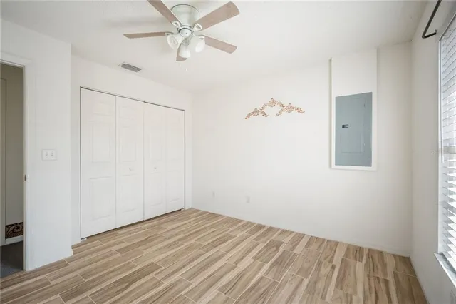 a view of a room with wooden floor and fan
