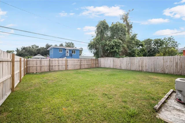 a view of a backyard with table and chairs